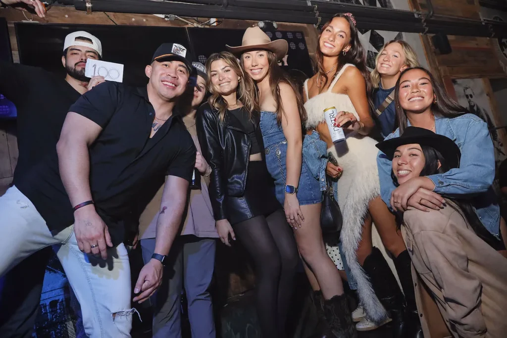 group of friends posing for a photo at nashville country bar