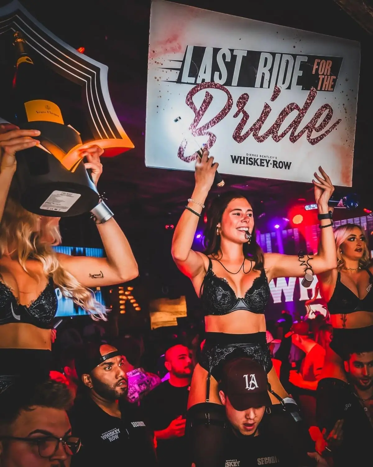 bottle service girls with a sign that says 'last ride for the bride' at scottsdale country bar & night club