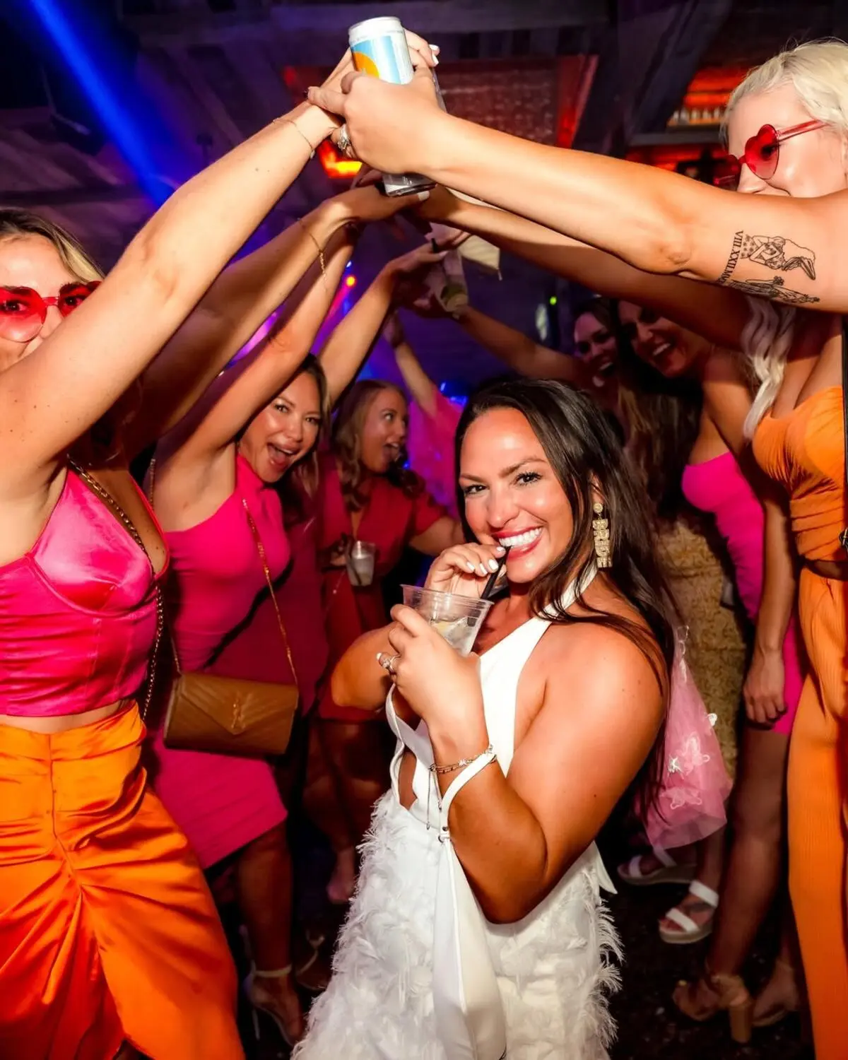 bachelorette party at country bar & night club in scottsdale, bride in white and girls in neon pink and orange
